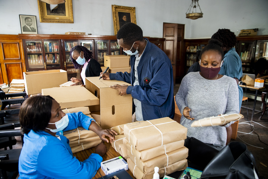 Improving conservation state of the archive by wrapping them in brown paper and twine and storing them in boxes off the library's floor